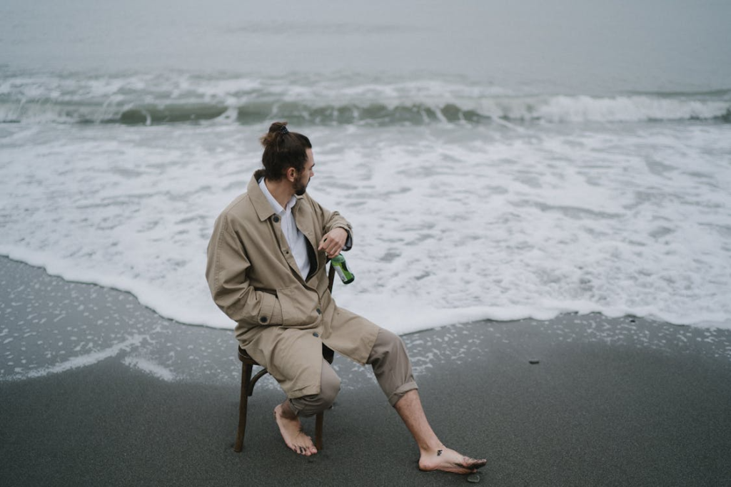 A man staring at the sea in silence