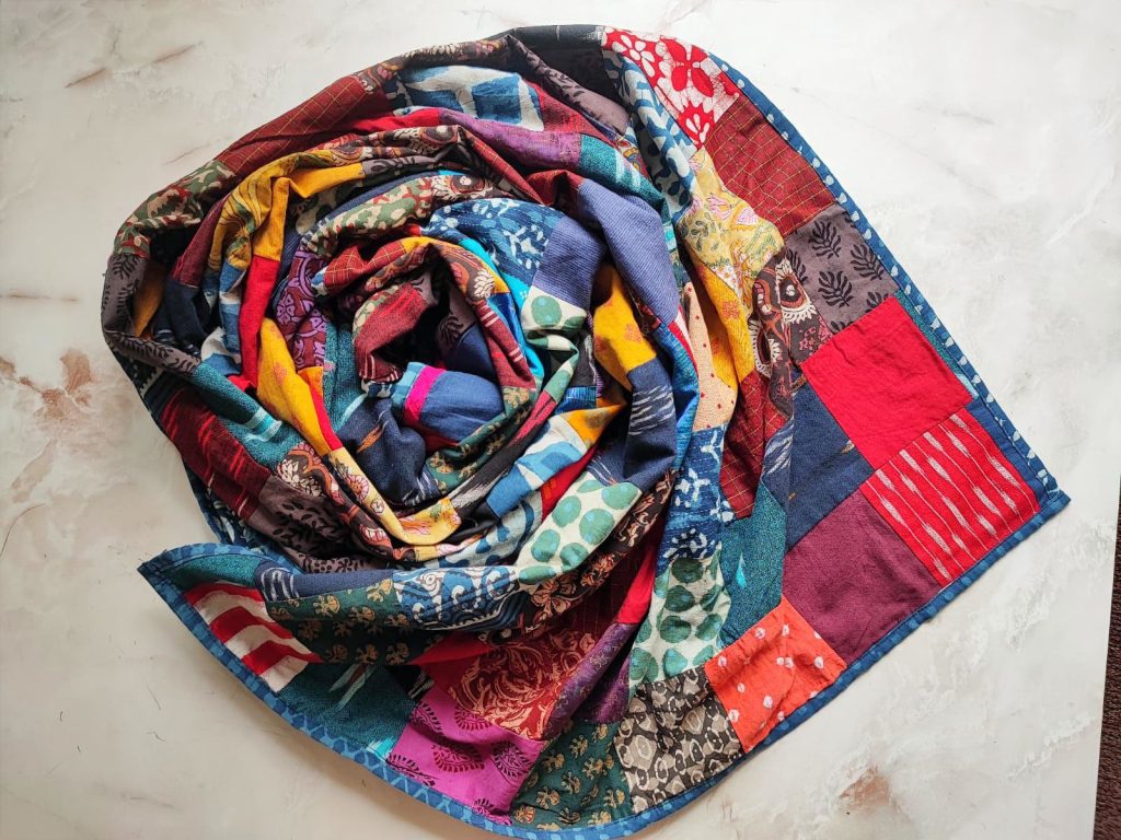 a patchwork handcrafted dupatta rolled in a creative fashion